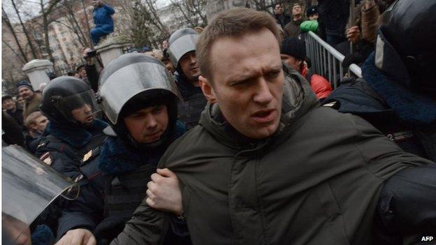 Police officers detain protest leader Alexei Navalny outside Zamoskvoretsky district court in Moscow, on 24 February