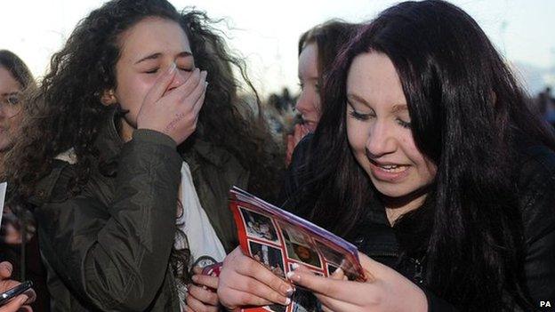 Morgan Evans (left), aged 14, from Sheffield and Chloe Harrison, aged 14, from Hull react after meeting Louis Tomlinson after he arrived at the Keepmoat Stadium, Doncaster where he is making his debut for the reserves.