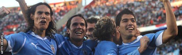 Uruguayans players Edinson Cavani, Alvaro Gonzalez, Diego Forlan and Uruguayan forward Luis Suarez celebrates at the end of the final of the 2011 Copa America football tournament against Paraguay.