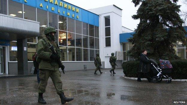 Armed men patrol at the airport in Simferopol, Crimea on 28 February 2014.