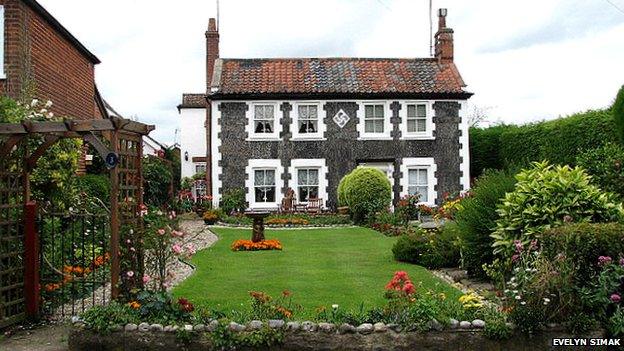 A curving swastika design on a pebble flint cottage near Aylsham in Norfolk