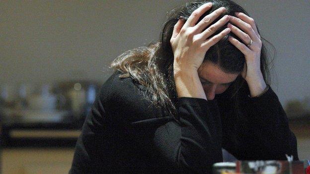 Woman with her head in her hands (file photo)