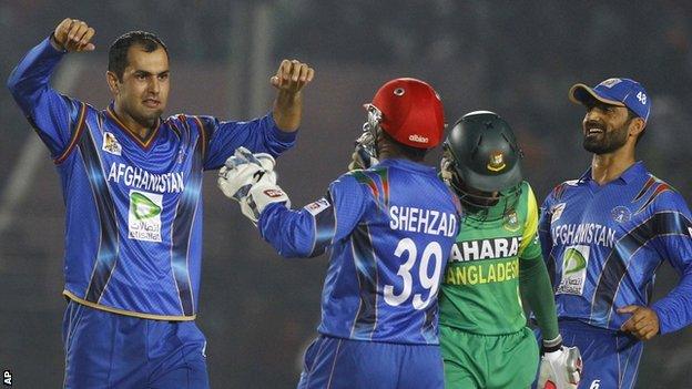 Mohammad Nabi (left) celebrates a wicket