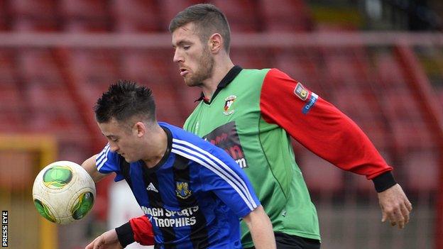 Glentoran's Mark Clarke battles with Armagh's Gareth Grimley at the Oval