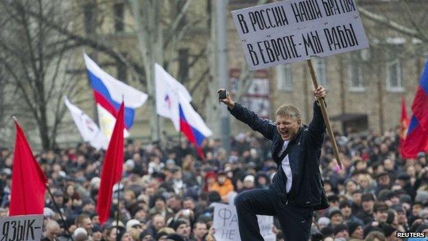 Pro-Russian protesters with Russian flags take part in a rally in central Donetsk