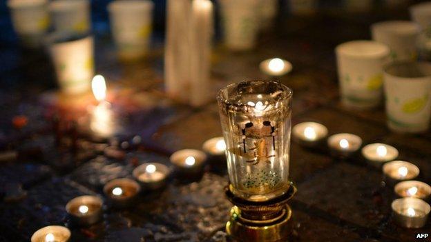 This picture taken on 2 March 2014 shows Chinese mourners lighting candles at the scene of the terror attack at the main train station in Kunming, southwest China's Yunnan province