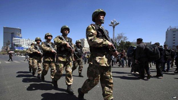 Armed paramilitary policemen patrol near the Kunming Railway Station in Kunming, in western China's Yunnan province Sunday, 2 March 2014