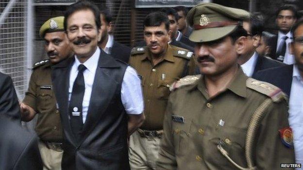 The Sahara group chairman Subrata Roy being escorted to a court in the city of Lucknow on February 28, 2014.