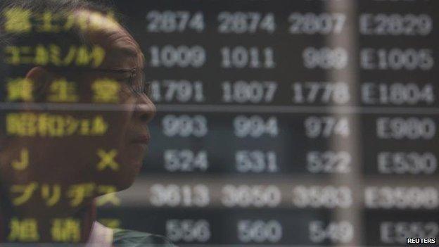 Electronic board showing stock prices outside a brokerage in Tokyo, 3 March