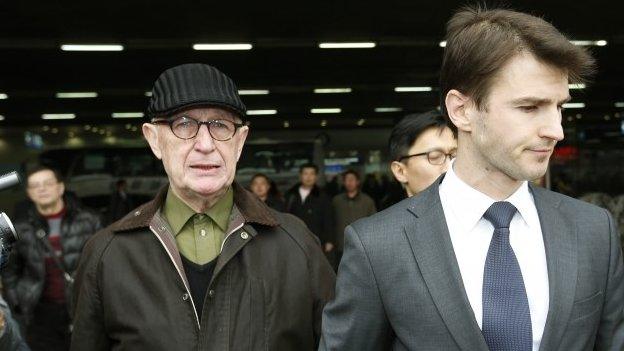 Australian missionary John Short, left, walks out from the airport terminal as he arrives at Beijing International Airport in Beijing, China, Monday, 3 March 2014