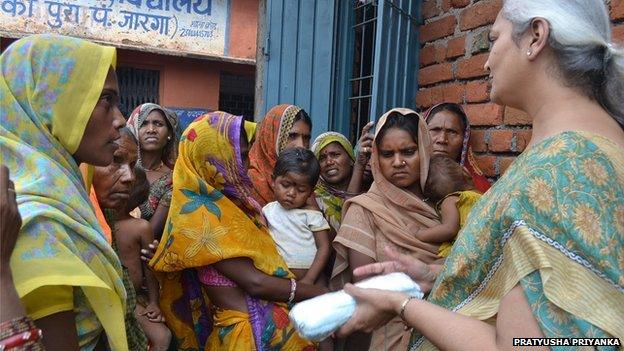 School principal Nishi Misra talking to women about hygiene