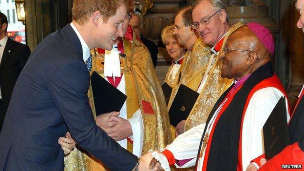 Prince Harry shakes hands with Archbishop Desmond Tutu