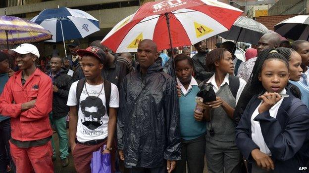 School children and members of the public try to see Oscar Pistorius as he leaves the Pretoria high court on 3 March 2014