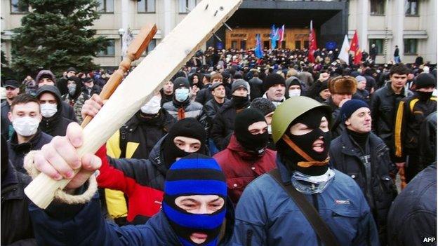 Pro-Russian activists wave clubs as they react after an unsuccessful attempt to storm a regional state administration building in the Black Sea city of Odessa on March 3