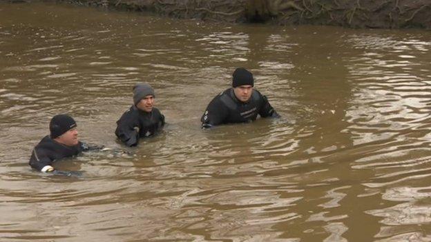 Three officers in river