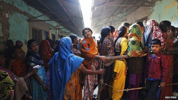 Voters line up outside a polling booth during the state assembly election in Delhi on December 4, 2013.