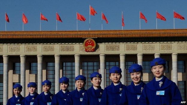 Chinese hostesses pose for photographers during the National People's Congress at the Great Hall of the People in Beijing, 5 March 2014