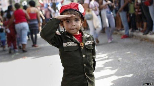 A child dressed as former Venezuelan President Hugo Chavez at a parade during the Carnival festival in Caracas on 4 March, 2014