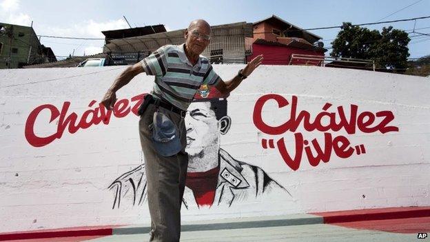 A man walks past a mural of Venezuela's late President Hugo Chavez in Caracas on 4 March, 2014