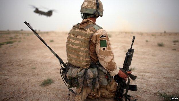 A British soldier secures a helicopter landing strip during operation in Kandahar Province, Afghanistan