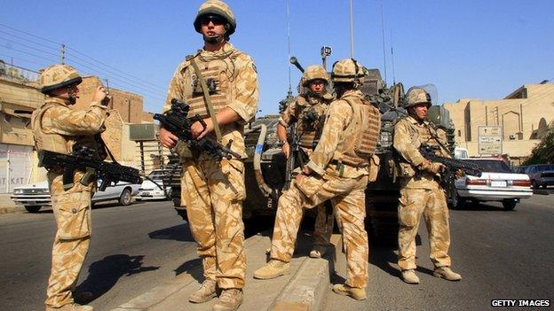 British soldiers patrol a street in the southern city of Basra, Iraq