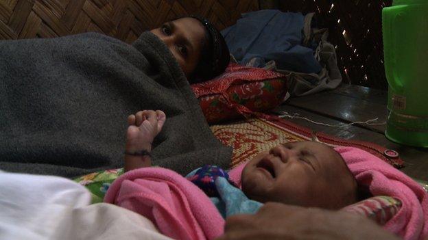 Rohingya mother Kurshidaka and her baby girl. Kurshidaka badly needs treatment for her infected wound from a caesarean section