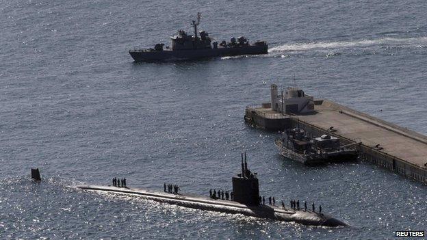 The Los Angeles-class nuclear powered attack submarine USS Columbus (SSN 762) (C) sails into a naval port to take part in Foal Eagle, an annual joint military exercise between the US and South Korea, in Busan, South Korea, 3 March 2014