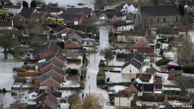 Water surrounds flooded properties in the village of Moorland