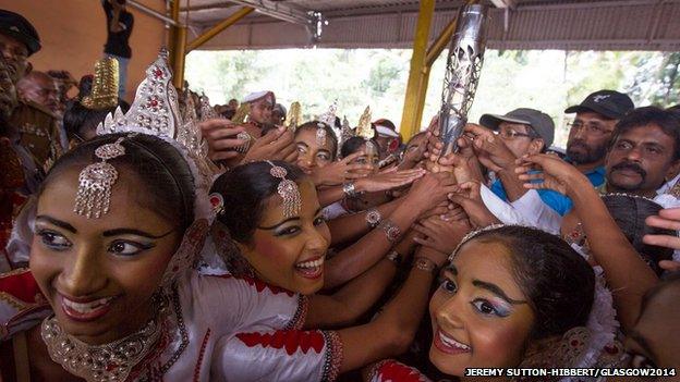 Traditional Sri Lankan dancers reach for the baton during arrival celebrations.