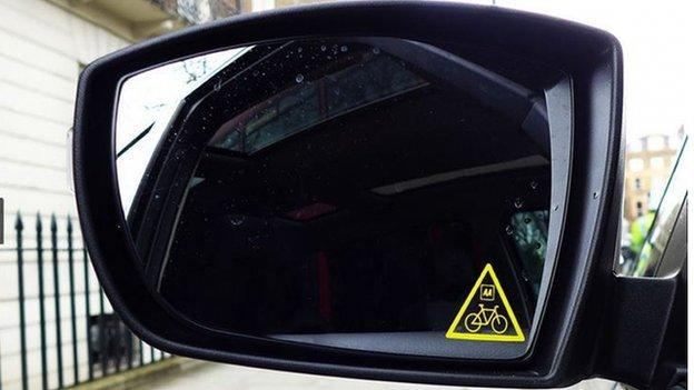 Think Bike sticker in a car wing mirror