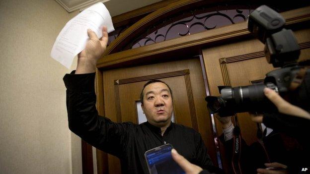 A Chinese relative of passengers aboard a missing Malaysia Airlines plane speaks to the media outside a holding room at a hotel in Beijing