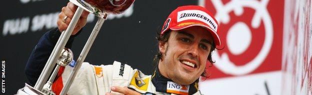 Fernando Alonso of Spain and Renault celebrates on the podium after winning the Japanese Formula One Grand Prix at the Fuji Speedway on October 12, 2008 in Shizuoka.