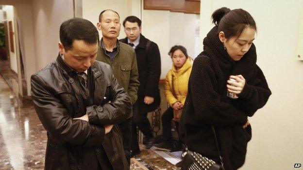 Family members arrive at a hotel which is prepared for relatives or friends of passengers aboard a missing airplane, in Beijing, China, on 9 March 2014