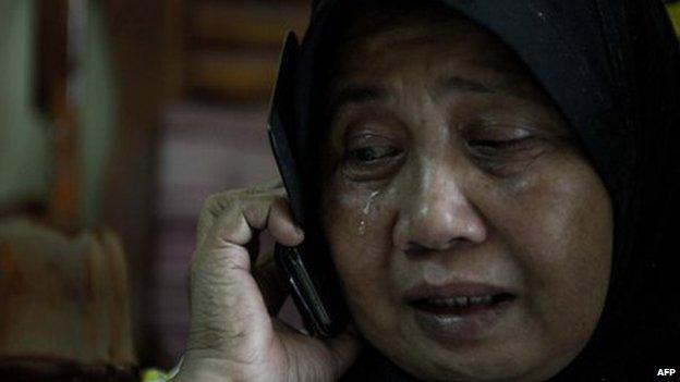 A relative of Norliakmar Hamid and Razahan Zamani, passengers on a missing Malaysia Airlines Boeing 777-200 plane, cries at their house in Kuala Lumpur on March 8, 2014. Malaysia and Vietnam on March 8 led a search for a Malaysia Airlines jet that has gone missing over Southeast Asia, as fears mounted over the fate of the 239 people aboard