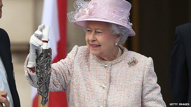 Queen Elizabeth II places her message to the Commonwealth Games in the Commonwealth Games Baton, during its launch ceremony