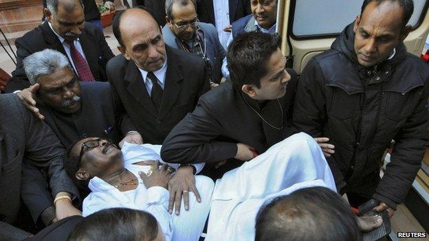 An MP is rushed to hospital in Delhi on February 13, 2014 after an MP fires pepper spray in the lower house