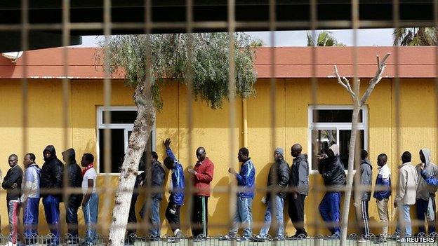 African migrants queue for lunch inside a refugee centre in the Spanish enclave of Melilla