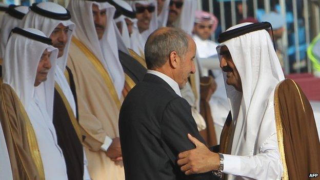 Qatar's Emir Sheikh Hamad bin Khalifa Al Thani embraces the former head of Libya's National Transitional Council, Mustafa Mohammed Abdul Jalil in December 2011