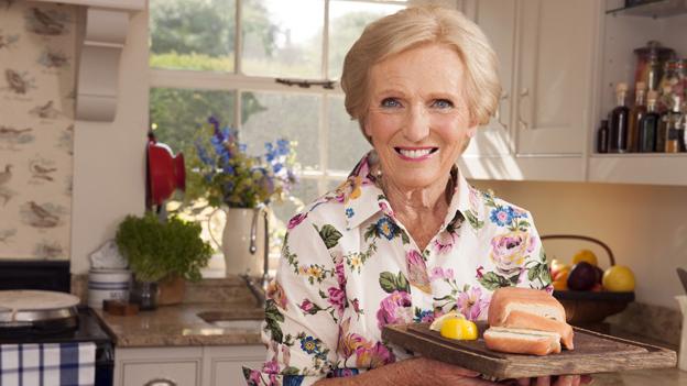 Mary Berry holding some cheese