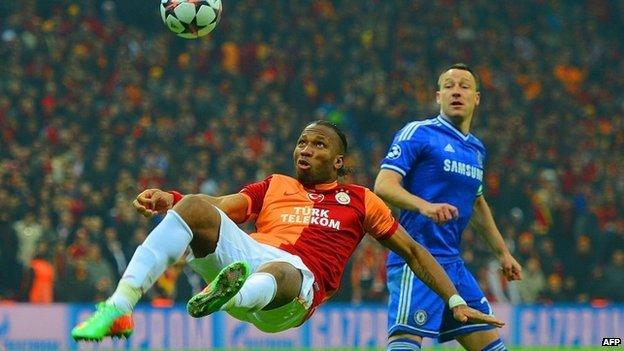 John Terry of Chelsea looks on as Didier Drogba of Galatasaray clears the ball during a match in Istanbul, Turkey on 26 February 2014