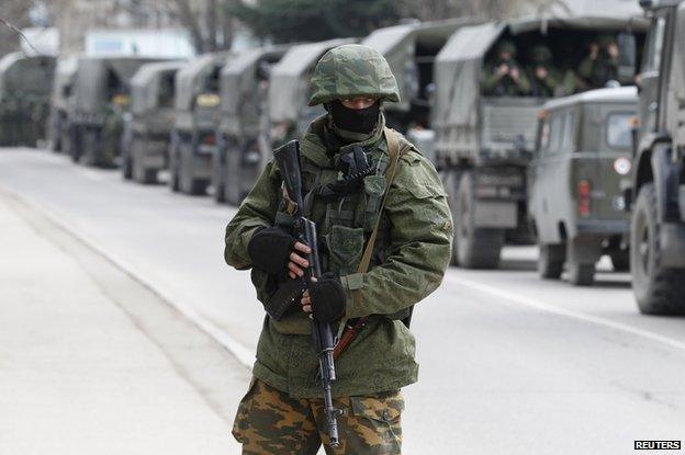 Armed servicemen wait in Russian army vehicles outside a Ukrainian border guard post in the Crimean town of Balaclava March 1, 2014.