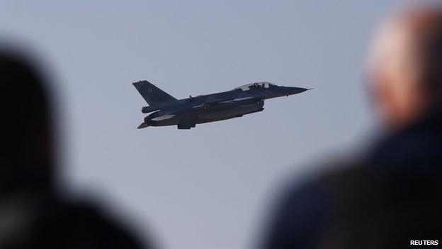 Media representatives watch an F-16 fighter jet take off as Poland"s President Bronislaw Komorowski (not pictured) visits the Lask airbase in central Poland March 11, 2014