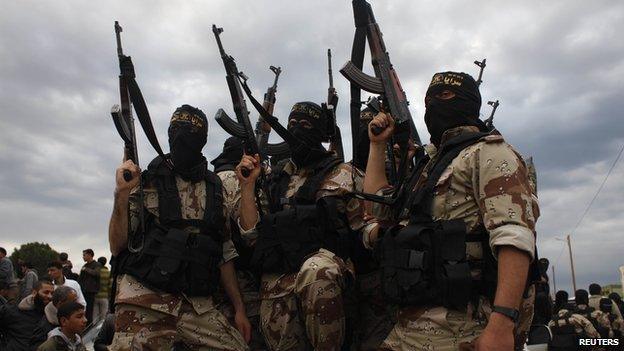 Islamic jihad militants take part in the funeral of three comrades, who were killed in an Israeli air strike, in Khan Younis in the southern Gaza Strip on 11 March 2014.