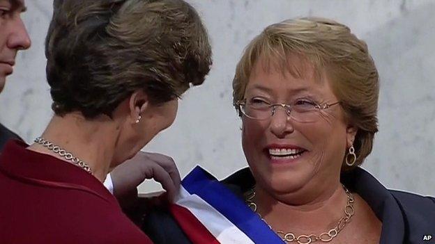 Michelle Bachelet (right) receives the presidential sash