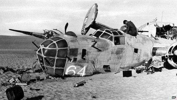 A member of a search party enters the hulk of the World War II B-24 bomber "Lady Be Good," found in the Libyan desert in May 1959