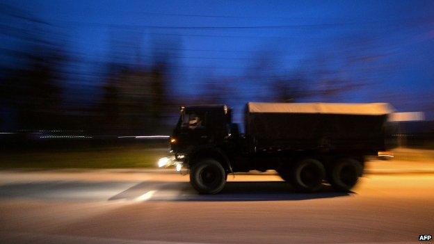 Russian military vehicles drive on the main road entering Sevastopol