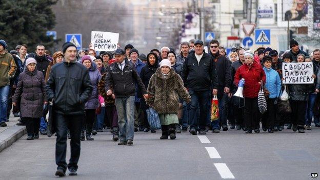 Demonstrators march during a pro Russia rally in Donetsk, Ukraine