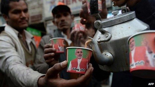 Paper cups bearing the portrait of Bharatiya Janata Party (BJP) prime ministerial candidate Narendra Modi are pictured as party workers distribute free tea at a roadside stall in New Delhi