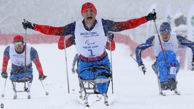 Roman Petushkov of Russia celebrates winning gold in men's cross country 1km sprint