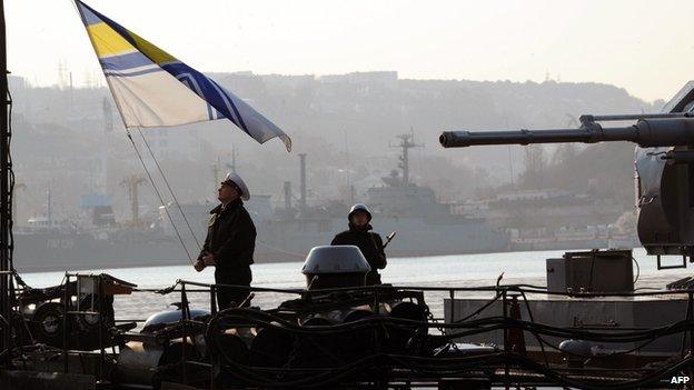 Sailor hoists Ukrainian flag on a naval ship in Sevastopol, Crimea, on 12 March 2014